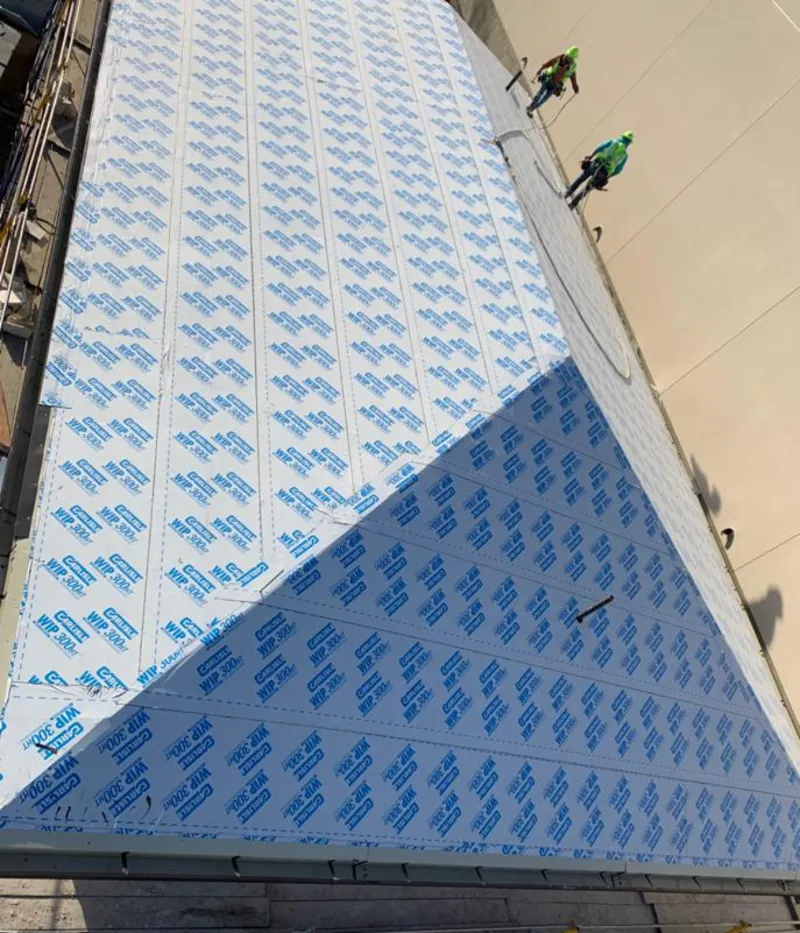 Professional roofers installing underlayment on a metal roof in West Salem